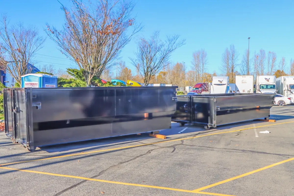 Professional dumpster rental service with roll-off container on residential driveway in Maitland